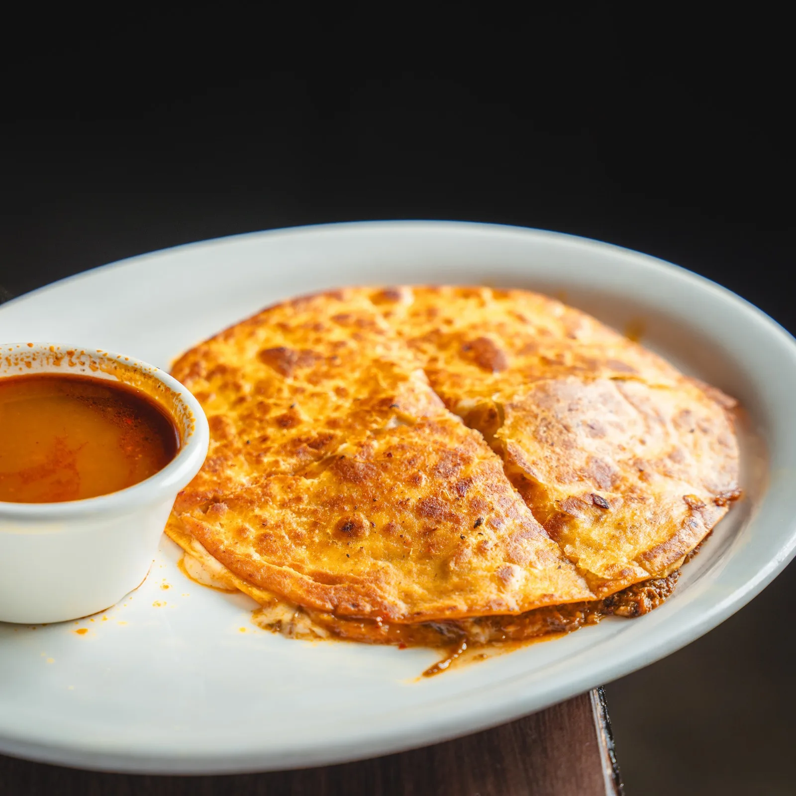 Pizza Birria at Patron Taqueria, beef birria and cheese with consomme